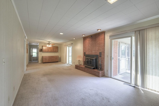 unfurnished living room featuring ornamental molding, light colored carpet, ceiling fan, and visible vents