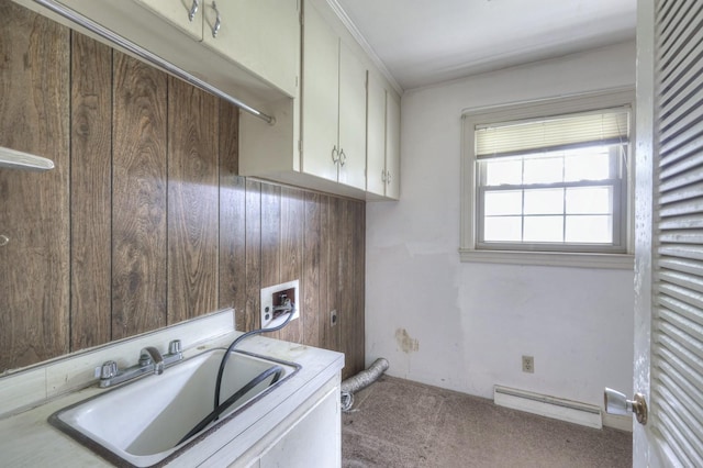 washroom featuring cabinet space, hookup for a washing machine, baseboard heating, carpet floors, and a sink