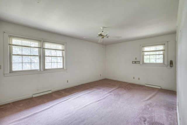 carpeted empty room with a baseboard heating unit and ceiling fan