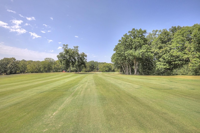 view of community with a yard and golf course view