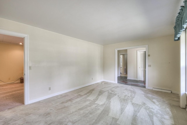 unfurnished room with baseboards, baseboard heating, and light colored carpet