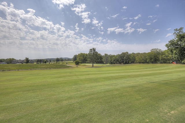 view of community with a yard and golf course view