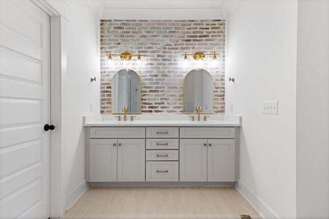 6816 Springwater St, Smyrna, TN 37167 - full bath featuring baseboards, brick wall, double vanity, and wood finished floors
