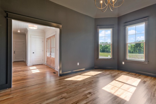 6816 Springwater St, Smyrna, TN 37167 - spare room with a chandelier, wood finished floors, and baseboards