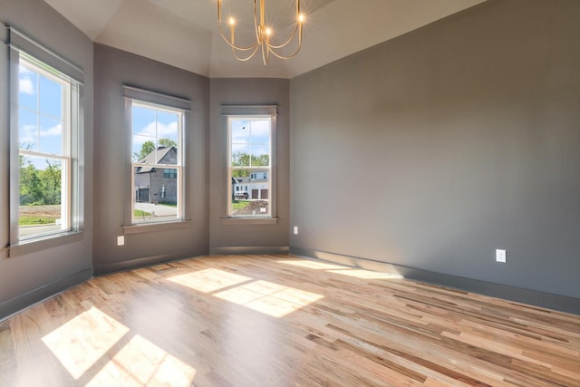 6816 Springwater St, Smyrna, TN 37167 - unfurnished room with a chandelier, plenty of natural light, wood finished floors, baseboards, and lofted ceiling
