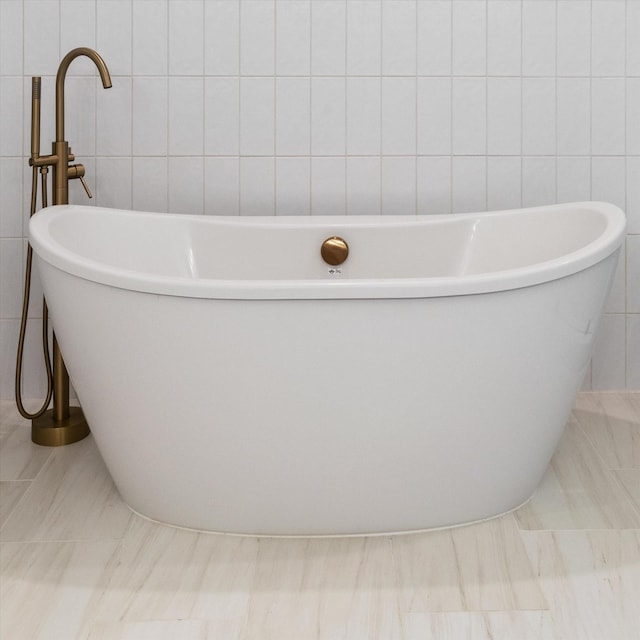 6816 Springwater St, Smyrna, TN 37167 - bathroom with tile walls, a freestanding bath, and tile patterned flooring