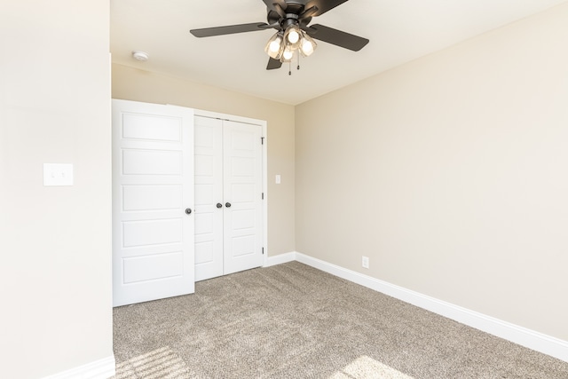 unfurnished bedroom featuring a closet, light colored carpet, and ceiling fan