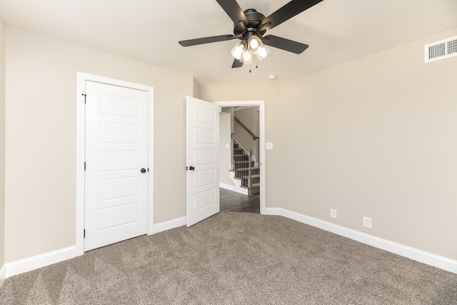 unfurnished bedroom with ceiling fan and carpet