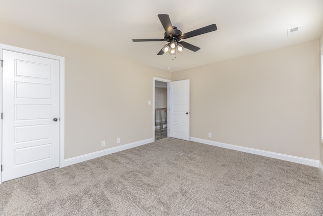 spare room featuring ceiling fan and carpet