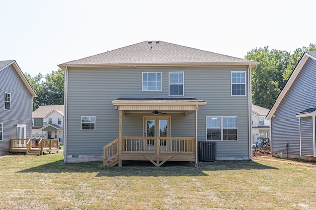 back of house featuring ceiling fan, a deck, and a yard