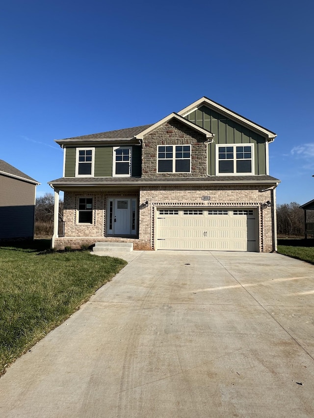 view of front of home with a front yard and a garage