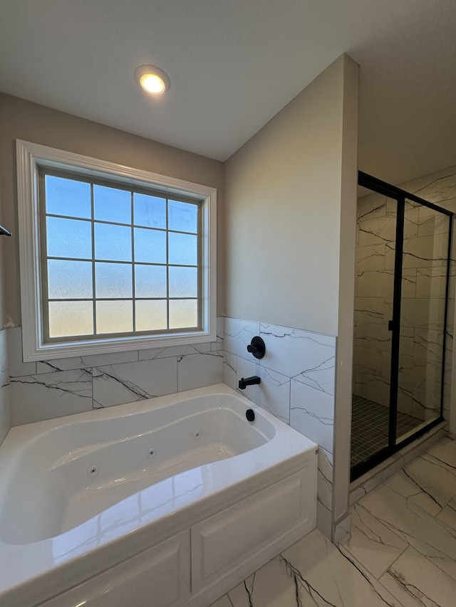 bathroom with shower with separate bathtub