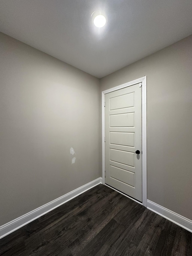 unfurnished room with dark hardwood / wood-style floors