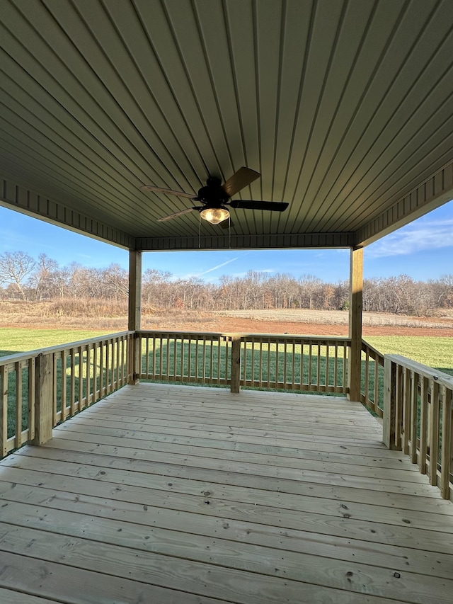 deck featuring ceiling fan and a rural view