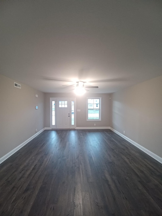 unfurnished room featuring ceiling fan and dark hardwood / wood-style floors