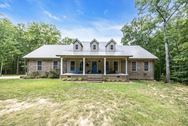 cape cod house with a front yard and covered porch