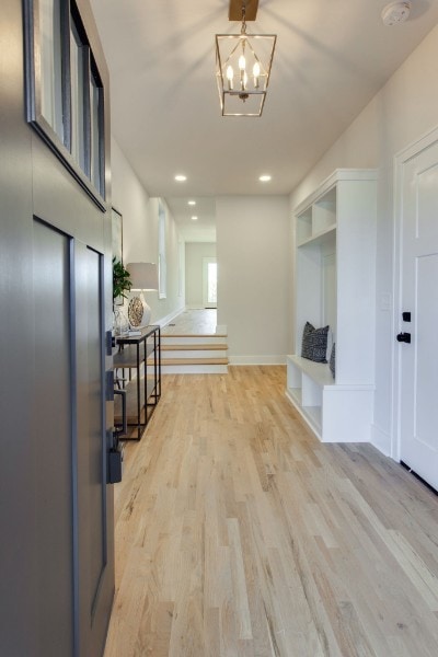 interior space featuring light hardwood / wood-style flooring and a notable chandelier