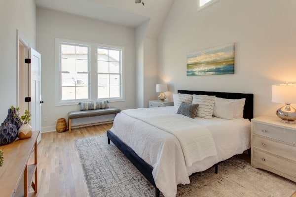 bedroom with light hardwood / wood-style flooring and vaulted ceiling