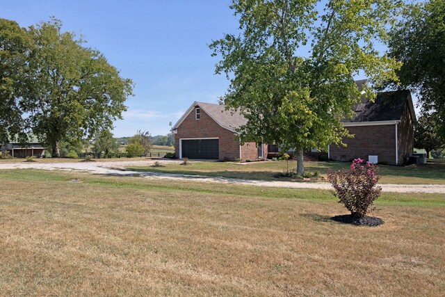 view of front of home featuring a front lawn and a garage