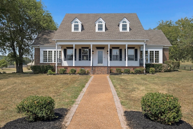 cape cod-style house with a porch and a front lawn