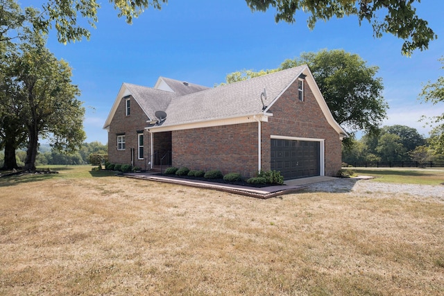 view of side of home with a yard and a garage