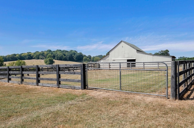 view of yard with an outdoor structure and a rural view