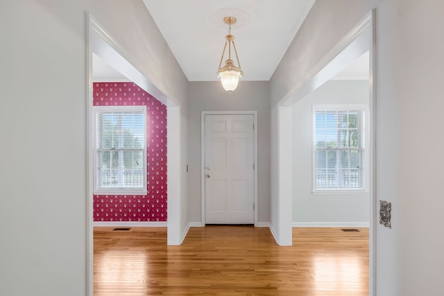 foyer featuring a notable chandelier and light hardwood / wood-style floors