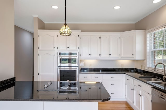 kitchen with light wood-type flooring, crown molding, white cabinetry, sink, and appliances with stainless steel finishes