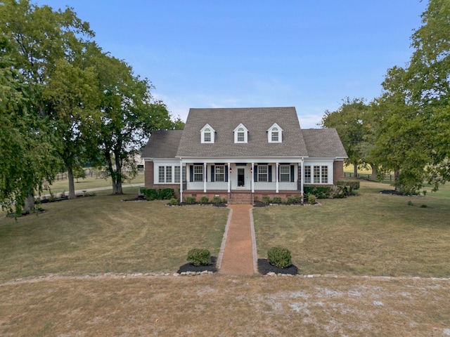 new england style home with a porch and a front yard