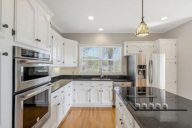 kitchen featuring stainless steel appliances, white cabinets, and light hardwood / wood-style floors