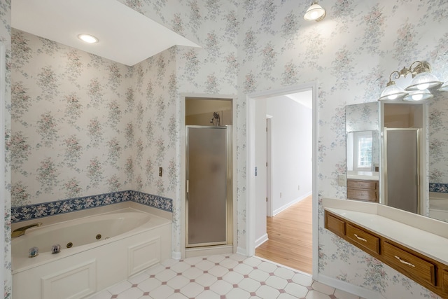 bathroom with vanity, wood-type flooring, and plus walk in shower