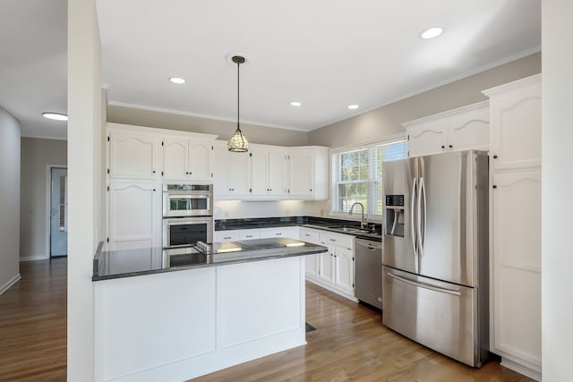 kitchen with light hardwood / wood-style flooring, stainless steel appliances, white cabinetry, and sink