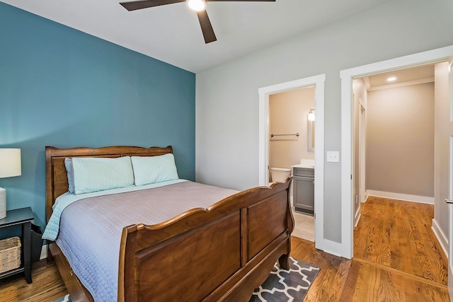 bedroom featuring ceiling fan, wood-type flooring, and connected bathroom