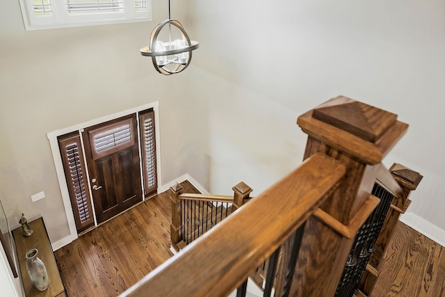 foyer with an inviting chandelier and dark hardwood / wood-style flooring