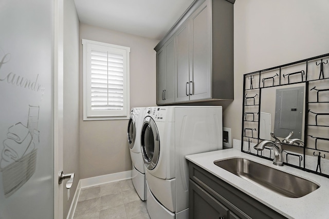 washroom featuring electric panel, washing machine and clothes dryer, cabinets, and sink