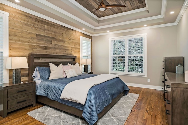 bedroom featuring wood walls, ceiling fan, dark hardwood / wood-style flooring, and ornamental molding