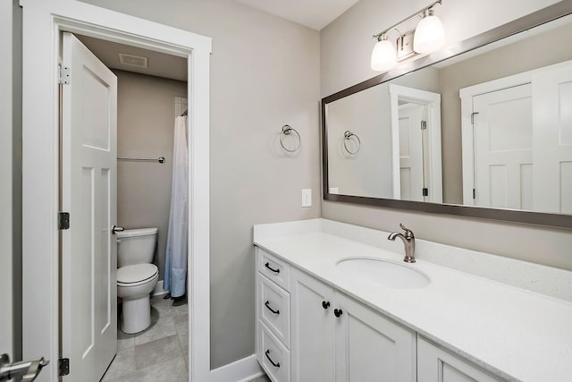 bathroom with tile patterned flooring, toilet, and vanity