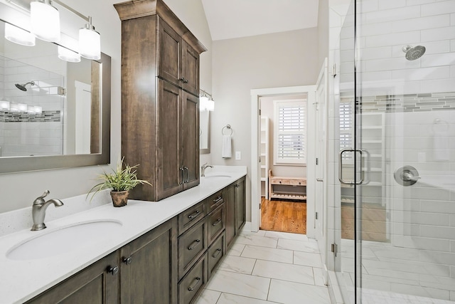 bathroom featuring vanity, vaulted ceiling, hardwood / wood-style flooring, and an enclosed shower