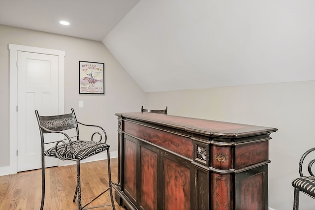 interior space featuring light wood-type flooring and lofted ceiling