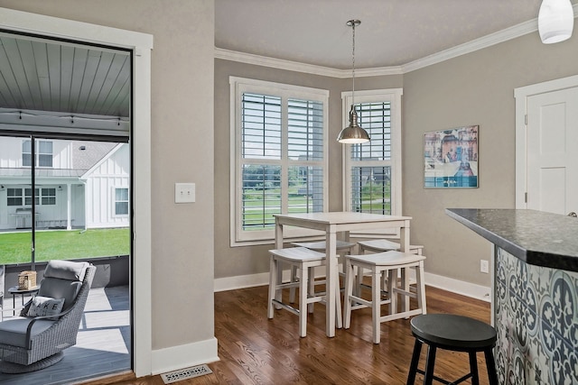 dining room featuring dark hardwood / wood-style flooring and crown molding