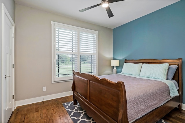 bedroom with dark wood-type flooring and ceiling fan