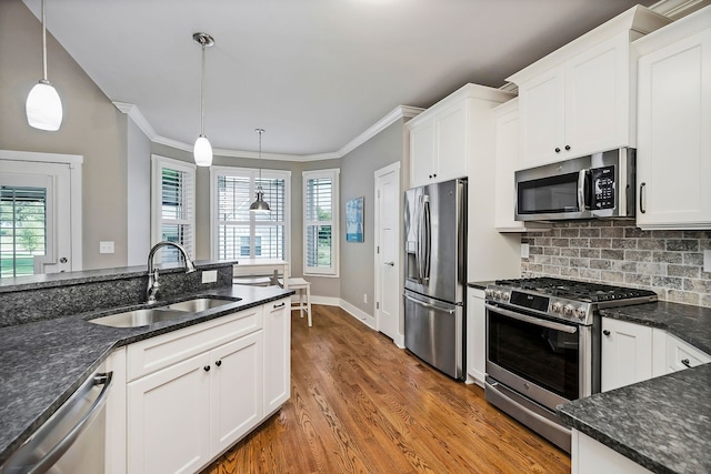 kitchen featuring white cabinets, hardwood / wood-style flooring, stainless steel appliances, and sink