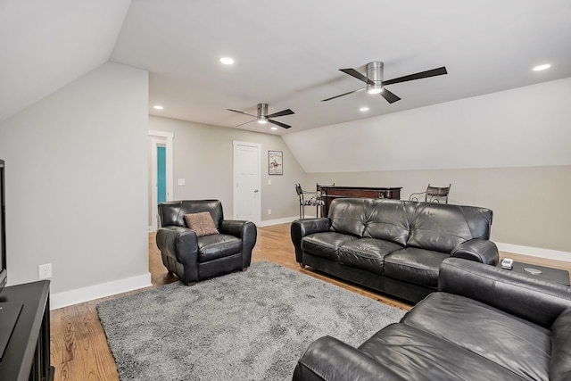 living room featuring lofted ceiling, wood-type flooring, and ceiling fan