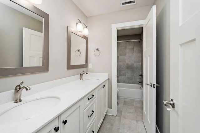 full bathroom with vanity, toilet, tiled shower / bath combo, and tile patterned floors