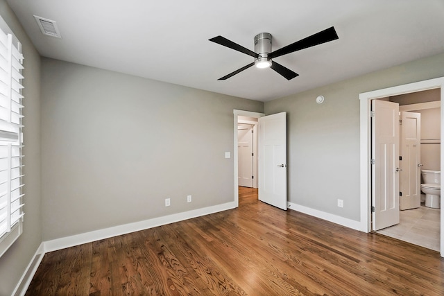 unfurnished bedroom featuring light hardwood / wood-style flooring, ceiling fan, and ensuite bath