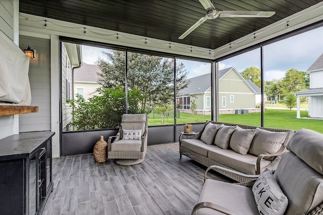 sunroom / solarium with ceiling fan and wooden ceiling