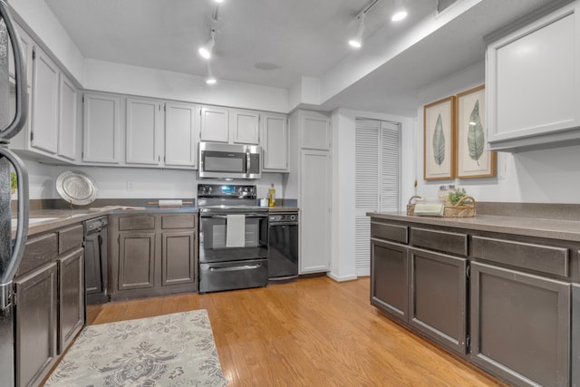 kitchen with stainless steel appliances, gray cabinetry, light wood-type flooring, and track lighting