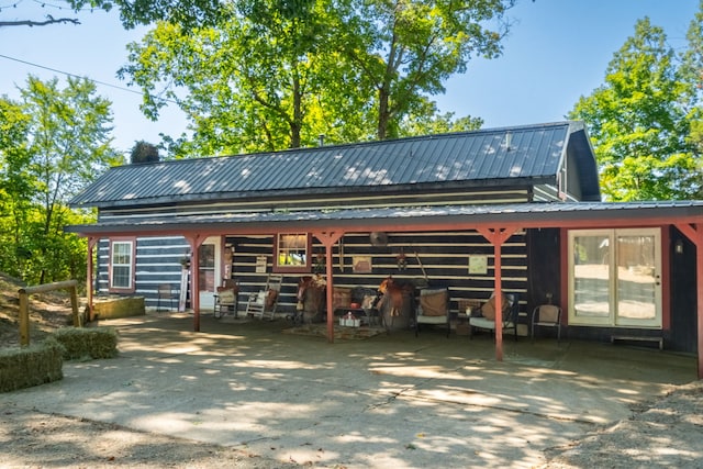 back of house with an outbuilding