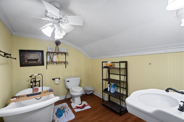 bathroom featuring toilet, crown molding, wood-type flooring, ceiling fan, and vaulted ceiling