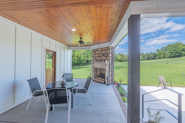 view of patio / terrace featuring an outdoor stone fireplace and ceiling fan